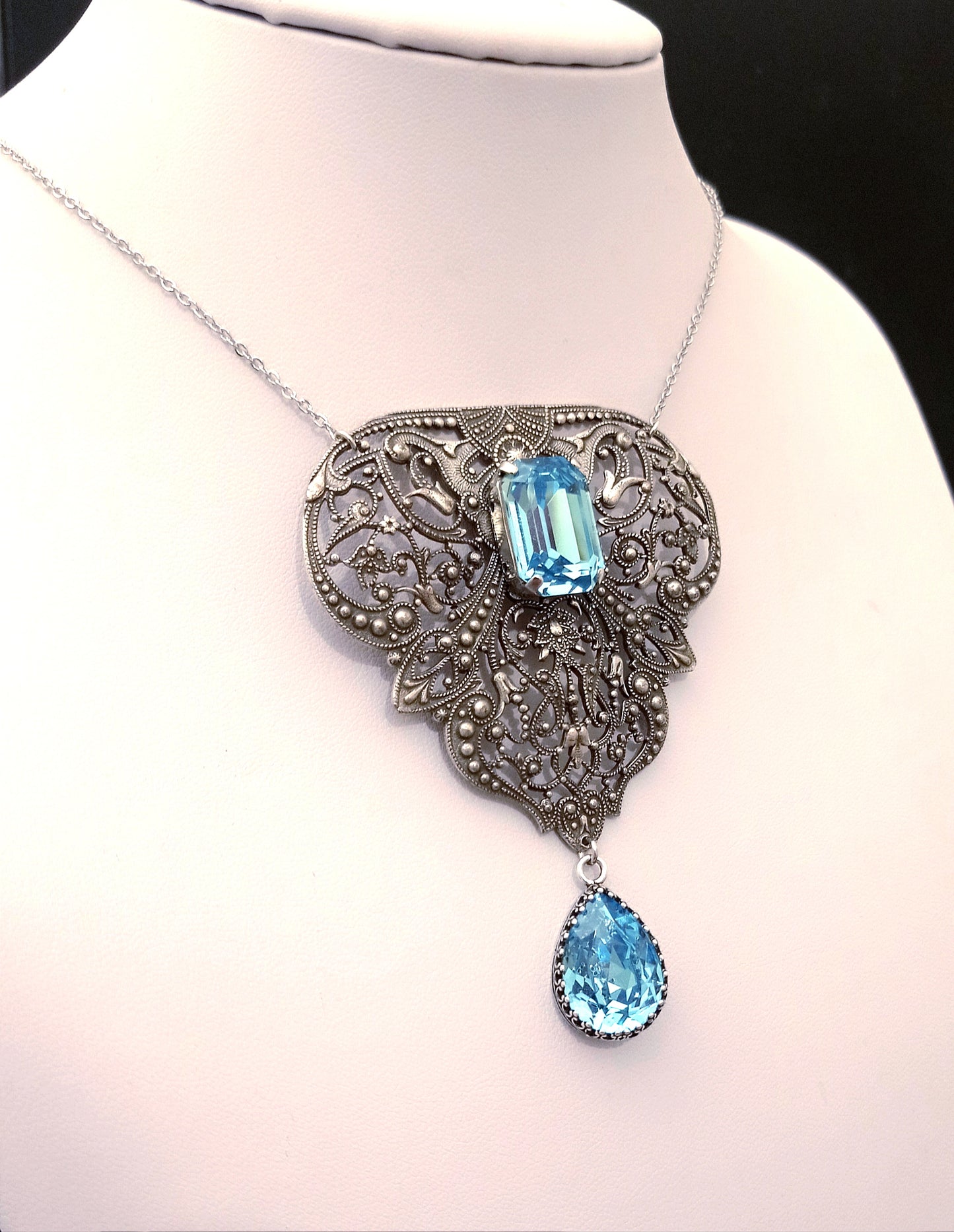 Belle epoque silver filigree necklace with aquamarine crystals.