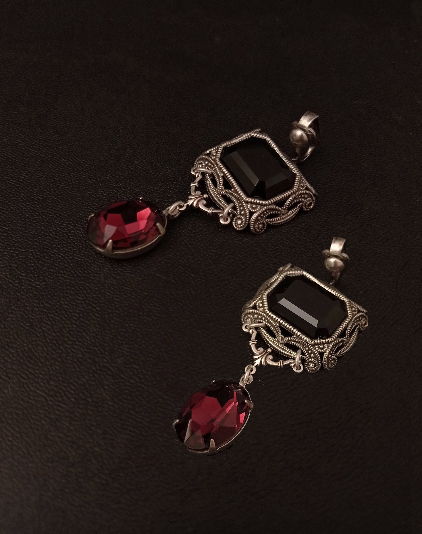 Pair of gothic earrings with black and burgundy Swarovski crystals and silver filigree design. Matching accessory for gothic necklace set.