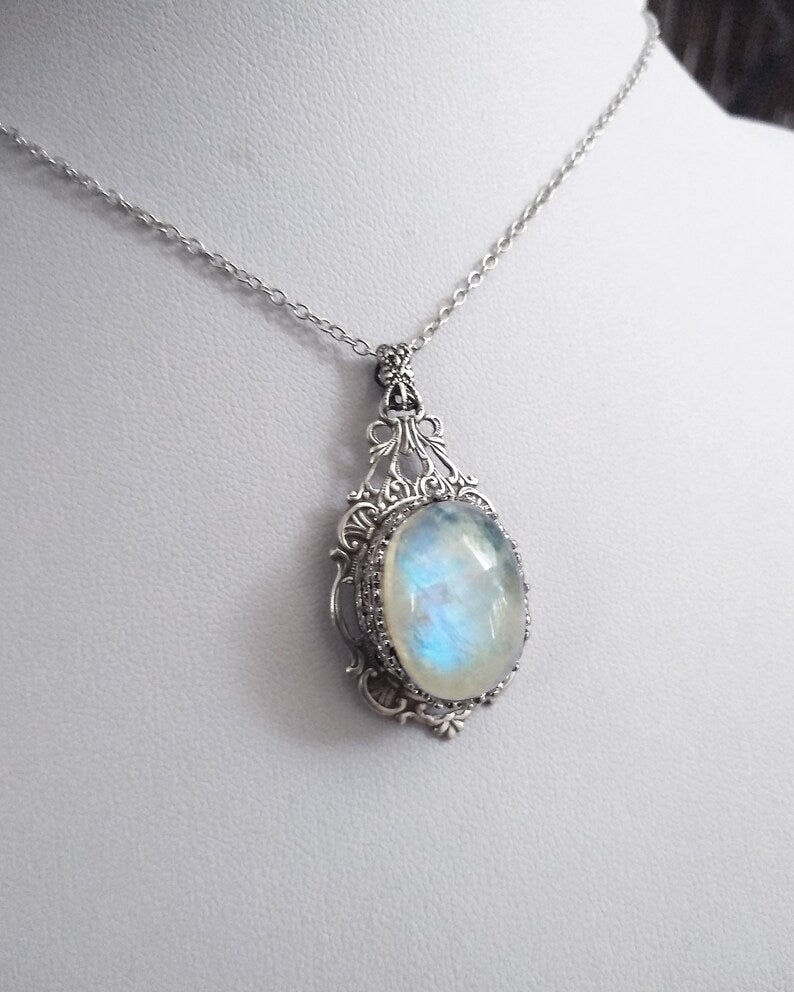 An exquisite Victorian style necklace featuring a large, real rainbow moonstone, exuding elegance and sophistication.