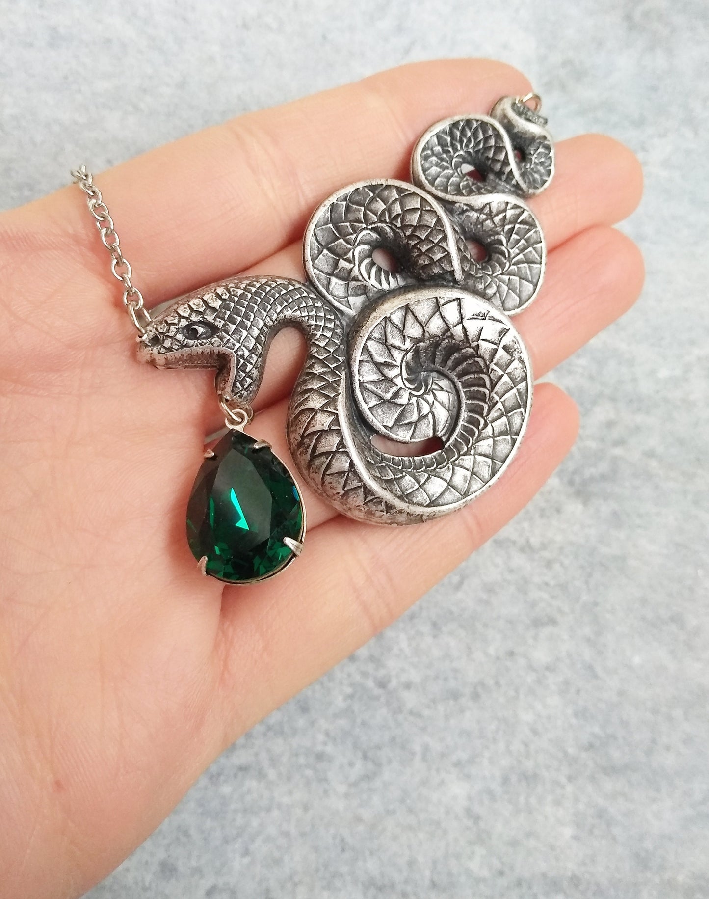 Silver snake necklace with green crystal drop