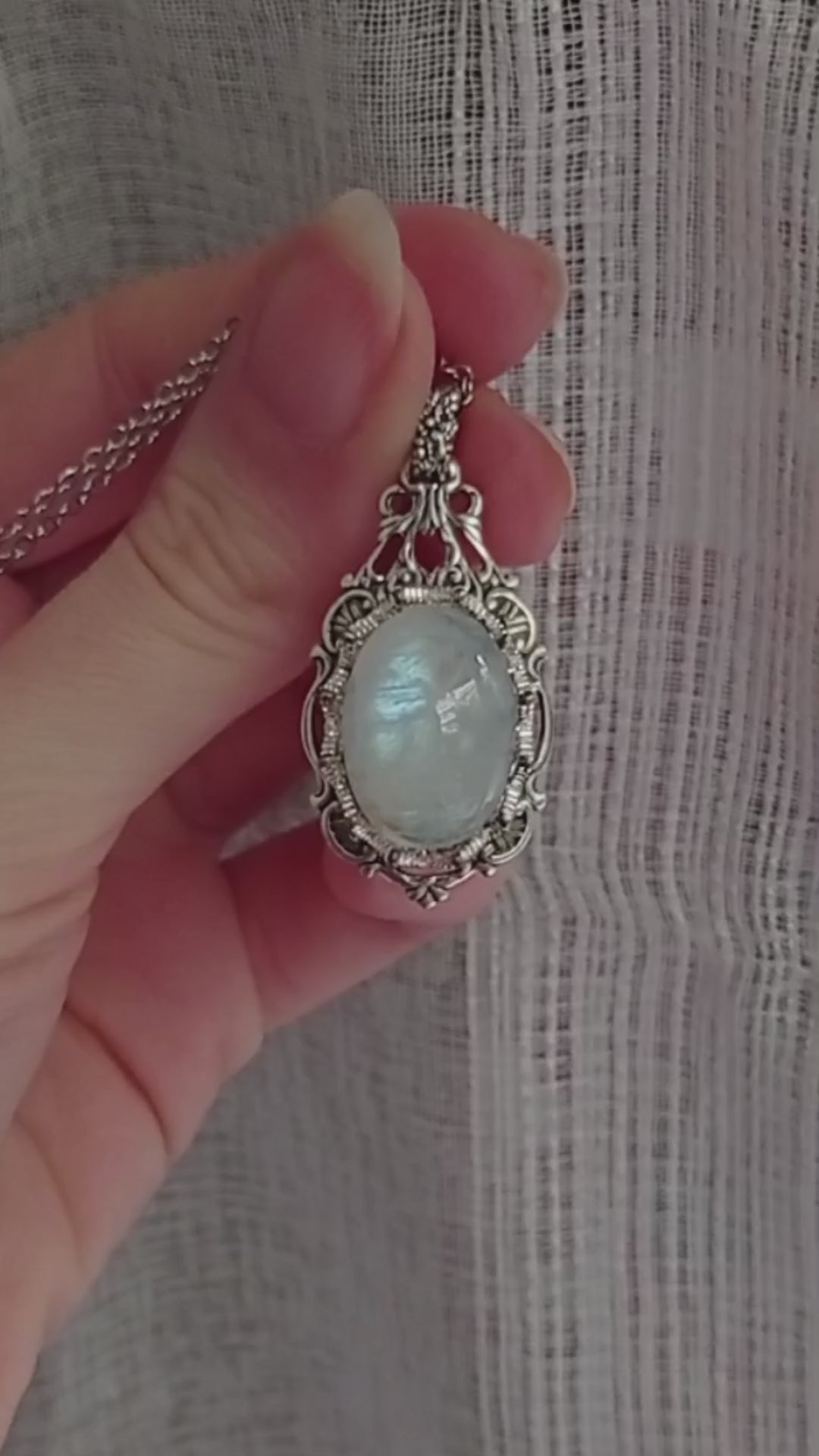 An exquisite Victorian style necklace featuring a large, luminous natural moonstone, exuding elegance and sophistication.