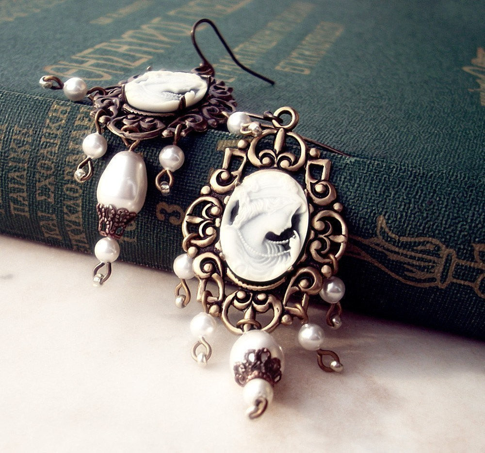 Charming earrings showcasing black and white woman portrait cameos, enhanced with lovely pearl accents.
