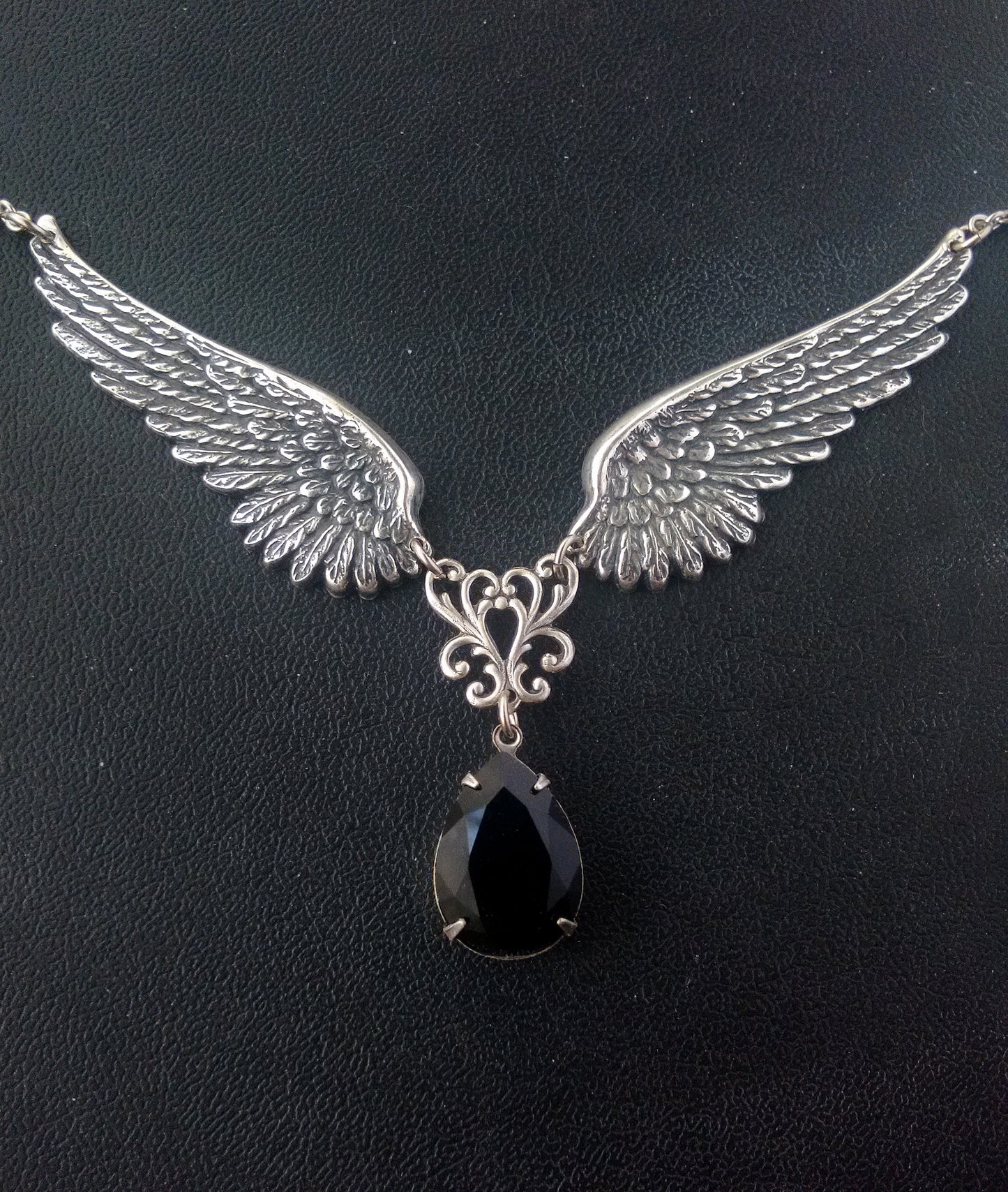 Add mythical power to your look with this gothic large angel wings necklace showcasing a crystal drop of your choice colour. Handcrafted and hypoallergenic. Gothic jewelry by Aranwen.