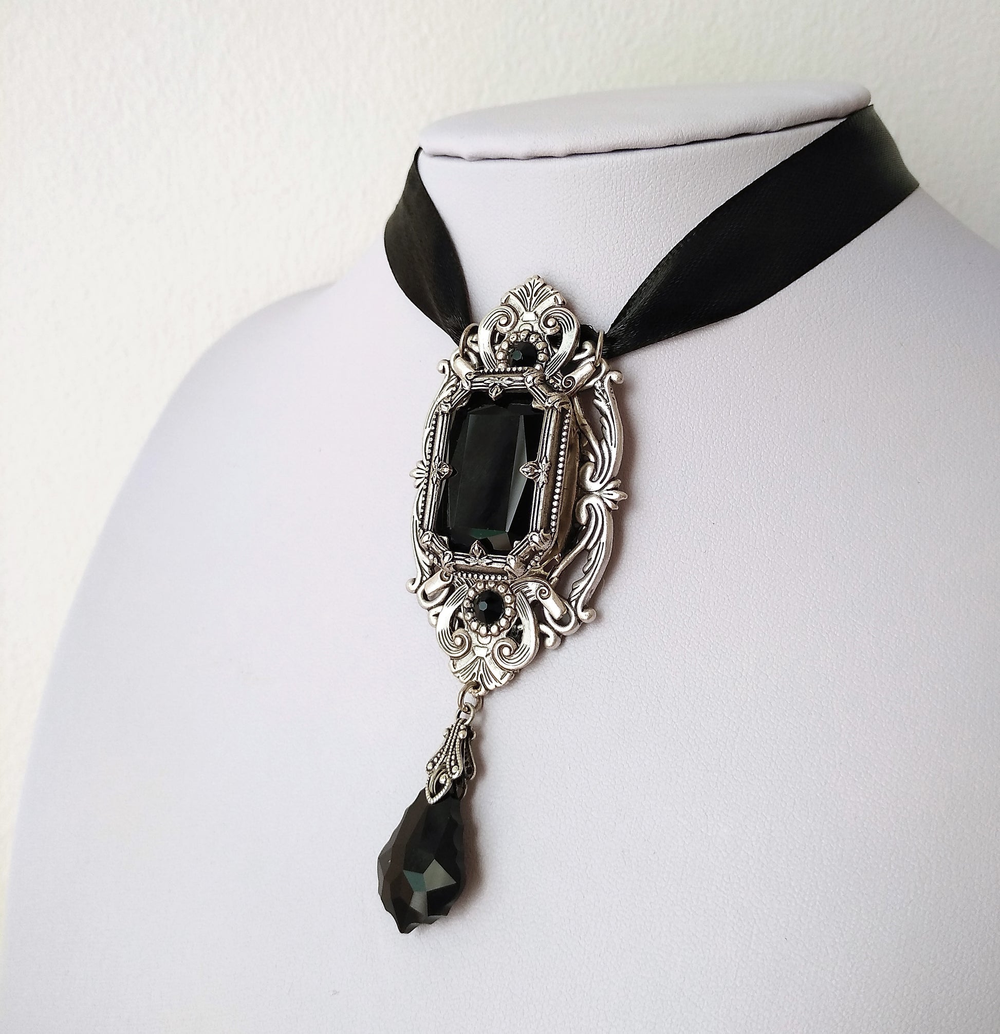 This gothic necklace features an exquisite silver arch resembling Gothic architecture windows, a timeless Octagon black crystal jewel and baroque shaped pendant, suspended by a satin ribbon. Victorian Gothic jewelry, vintage style jewelry, statement necklace.