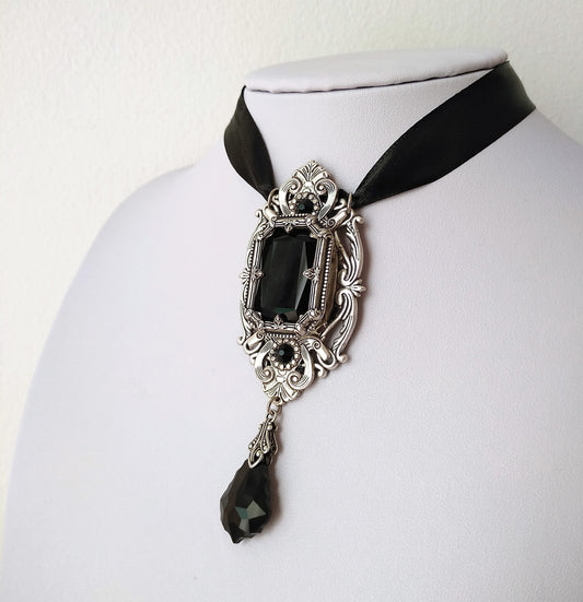 This gothic necklace features an exquisite silver arch resembling Gothic architecture windows, a timeless Octagon black crystal jewel and baroque shaped pendant, suspended by a satin ribbon. Victorian Gothic jewelry, vintage style jewelry, statement necklace.