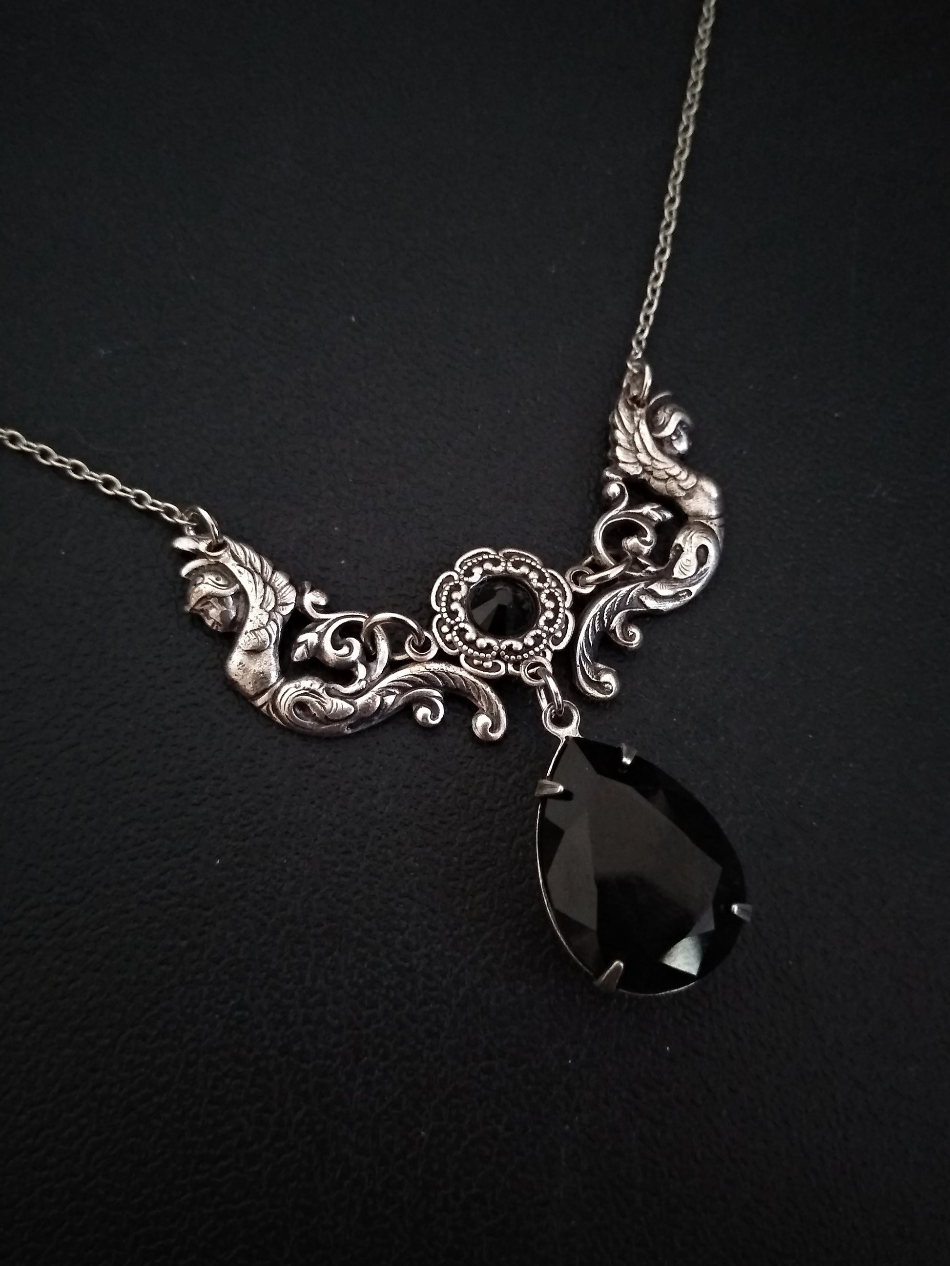 Victorian Gothic necklace featuring a beautifully detailed center piece with two antiqued silver angels supporting two sparkling Swarovski crystals between them.
