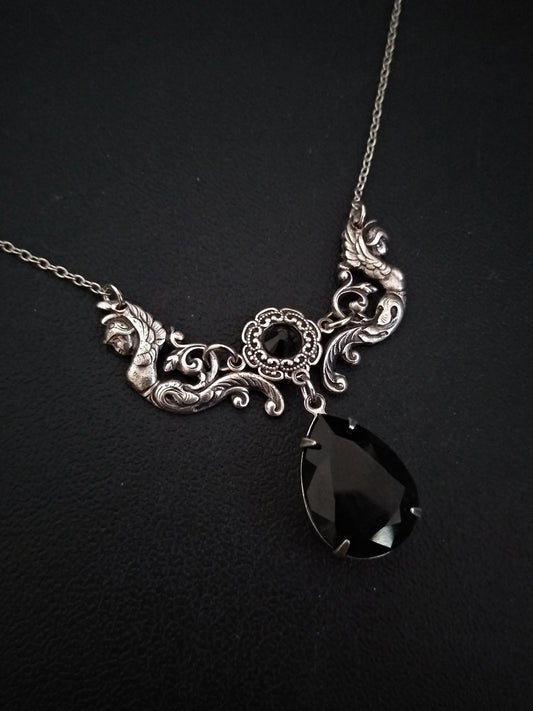 Victorian Gothic necklace featuring a beautifully detailed center piece with two antiqued silver angels supporting two sparkling Swarovski crystals between them.
