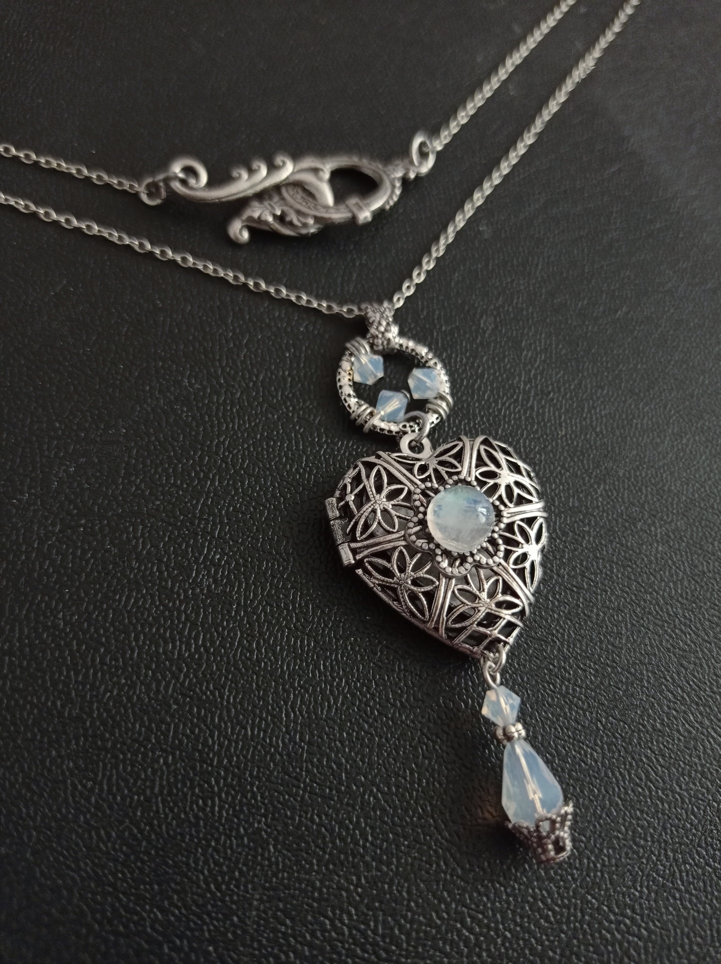 Express your romantic side with this vintage style antiqued silver filigree Heart shaped Locket Necklace with Moonstone cabochon and White opal Crystals. Victorian jewelry by Aranwen.