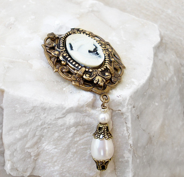 Add romance to your look with this victorian gothic brooch featuring ornate silver l settings, a white on black cameo of a lady's profile, a black flower and black pearls. Victorian Gothic jewelry by Aranwen.